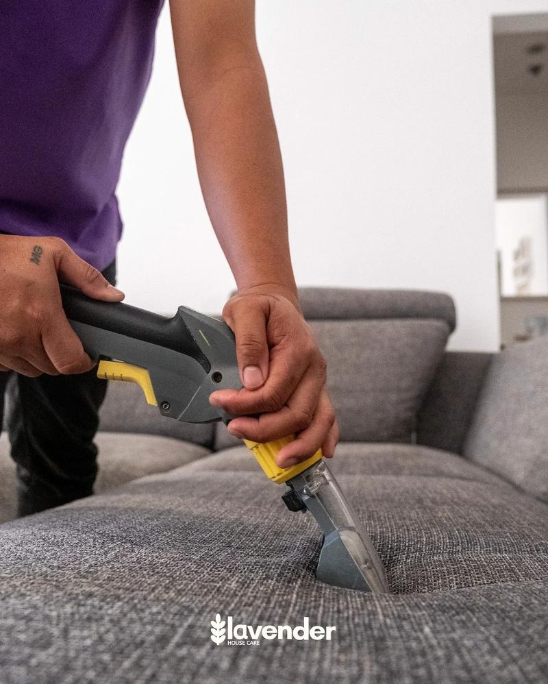 Professional sofa clean from Lavender Housecare in Dubai. Cleaner is using a Karcher upholstery machine and making sure all bacteria and dust is removed from the sofa.